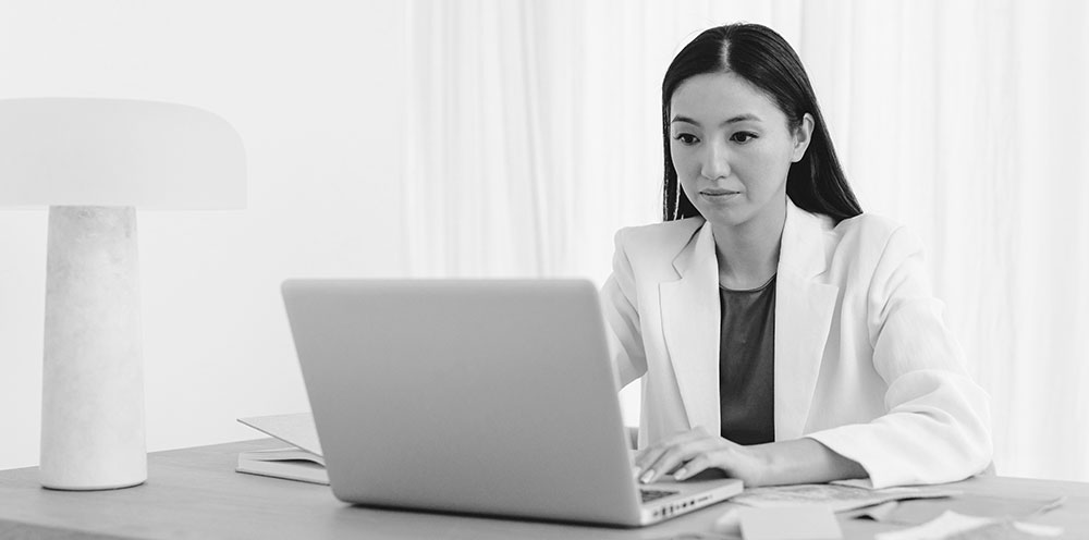 woman working on computer as boutique executive recruiter